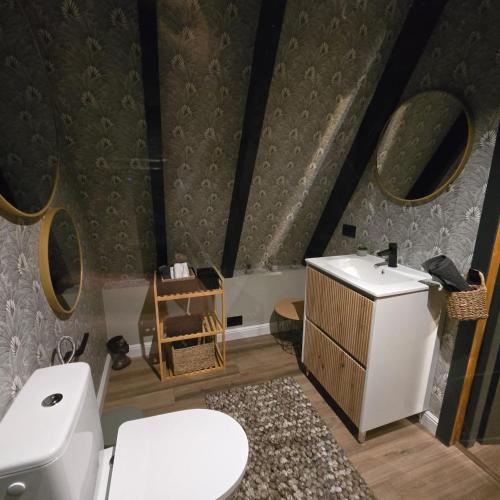 ein Badezimmer mit weißer Toilette und Waschbecken in der Unterkunft FreeDom Chalet in Verneşti