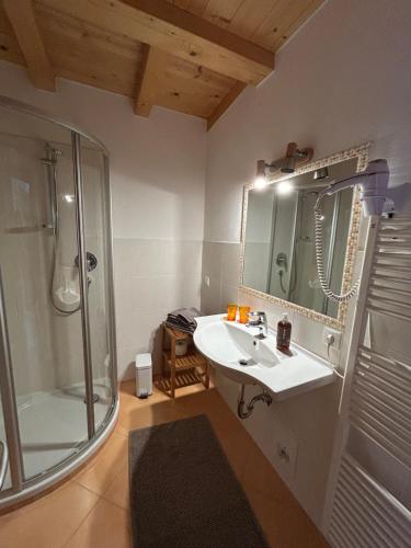 a bathroom with a sink and a shower at Kastnerhof in Meltina