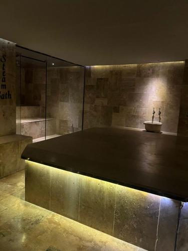a bench in a room with a stone wall at Grand Horizon Apart Hotel in Alanya