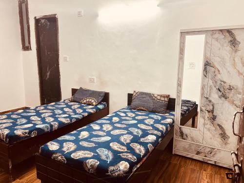 a room with two twin beds in it at BTS STAY- Singh Niwas in Ghaziabad
