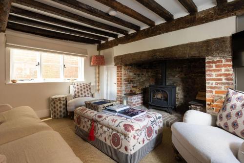 a living room with a fireplace and a couch at The Nook by The Butler Collection in Petworth