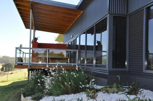 a house with glass windows on the side of it at Black Rock Retreat in Howth