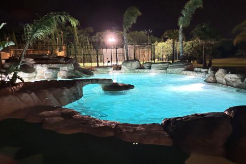 a large swimming pool at night at Cambrils Paradise in Cambrils