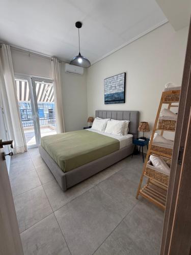 a bedroom with a bed and a ladder in it at Feels Like Home - Agrinio Suites in Agrinio