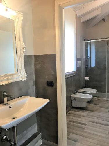 a bathroom with a sink and a toilet at Penthouse Apartment Desenzano in Desenzano del Garda