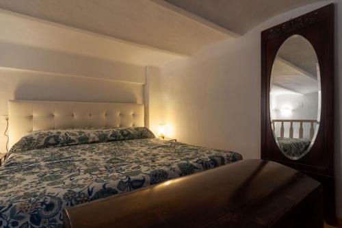 a bedroom with a bed and a large mirror at Appartamento MO in Follonica