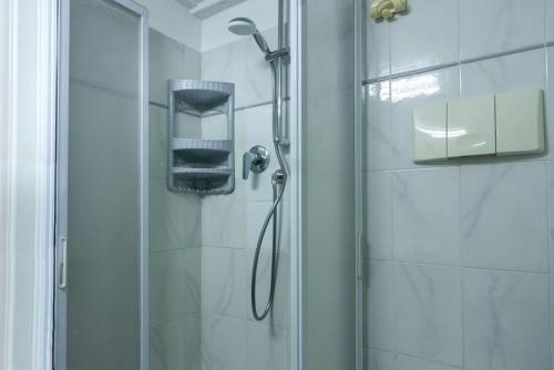 a shower with a shower head in a bathroom at Appartamento MO in Follonica
