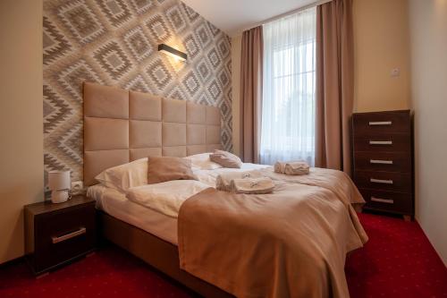 a bedroom with a bed with two towels on it at OW Sorrento in Bystrzyca Kłodzka