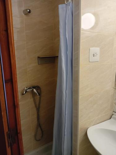 a shower with a shower curtain in a bathroom at Hostal Collsacabra in L’ Esquirol