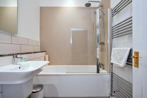 a bathroom with a sink and a tub and a shower at Finest Retreats - The Park in Onibury