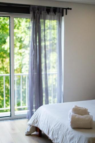 a bedroom with a bed and a large window at Sousa Horizonte - Louredo in Vieira do Minho