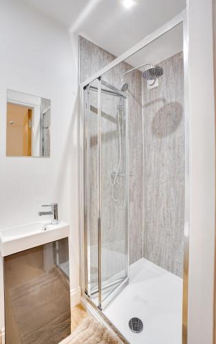 a bathroom with a shower and a sink at Apt 1 Armatage Flats, Eyemouth in Eyemouth
