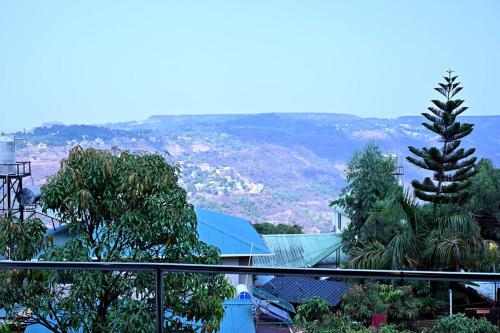 a view of a city from a balcony at Hotel Sunrise, Panchgani in Panchgani