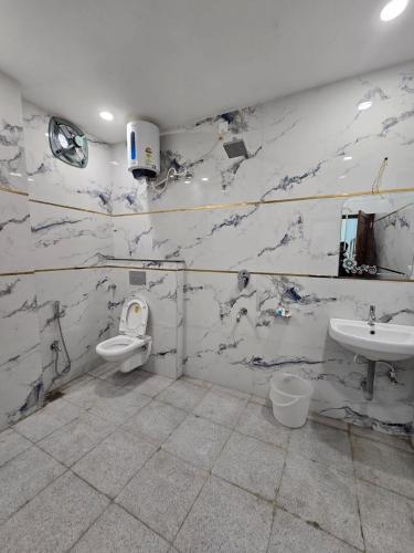 a bathroom with a toilet and a sink at Hotel The Castle Inn in Varanasi