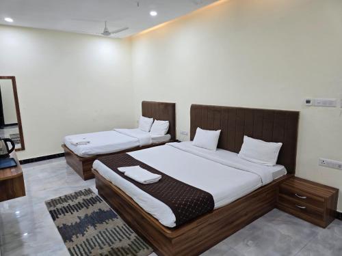 two twin beds in a room with at Hotel The Castle Inn in Varanasi