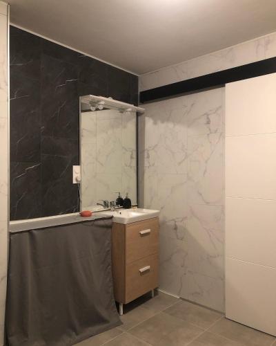 a bathroom with a sink and a mirror at Chez Nath House in Sedan