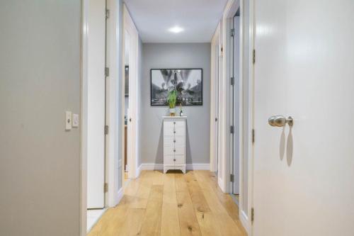 a hallway with a table and a picture on the wall at Luxury & Central 2 Bedroom Ormeau Road Apartment in Belfast