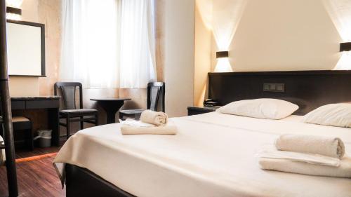 a hotel room with two beds with towels on them at Hotel Güleryüz 2 in Antalya