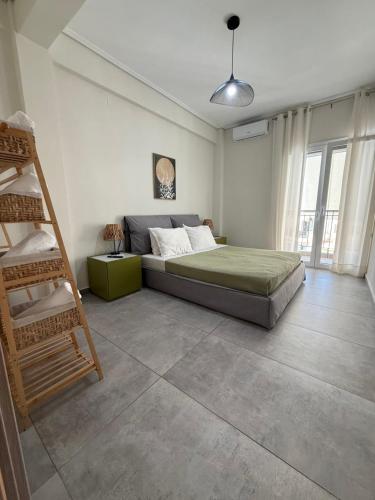 a bedroom with a bed and a ladder in it at Feels Like Home 2 - Agrinio Suites in Agrinio