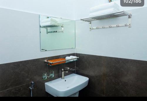 a bathroom with a white sink and a mirror at Mountain View Hostel in Bố Trạch