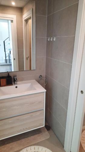 a bathroom with a sink and a mirror at Costa Blanca Suit in Arenales del Sol