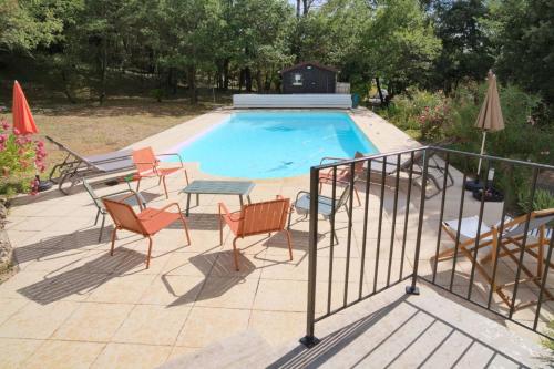 a patio with a pool with chairs and a table at Holiday Home nature and swimming pool in Provence ! in Mérindol