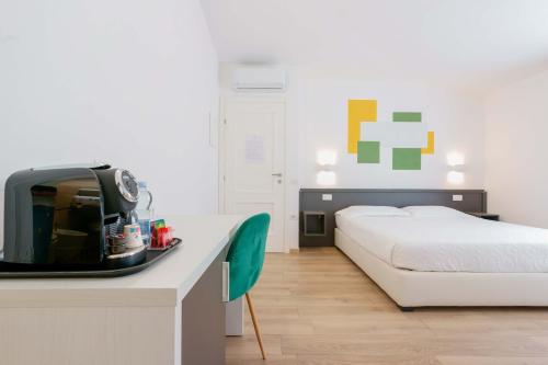 a hotel room with a bed and a table with acomputer at Admayora Guest House in Villasimius