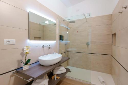 a bathroom with a white sink and a shower at Admayora Guest House in Villasimius
