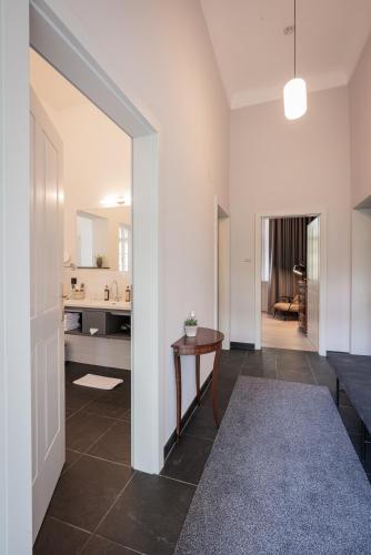 a living room with a table and a hallway at Boutique Hotel Zum Oberjäger, Schloss Lackenbach in Lackenbach