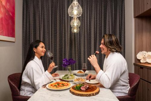 two women sitting at a table eating food at THE skM TOKYO HOTEL & DINING in Tokyo