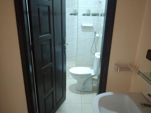 a bathroom with a toilet and a sink and a shower at اقامة الشام in Laayoune