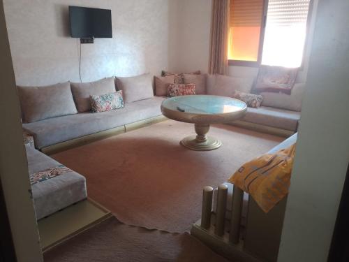 a living room with a couch and a table at اقامة الشام in Laayoune