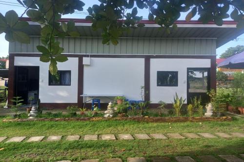 a house with a white facade at Seven Waves Beachfront Residence - La Union in Bagbag Oeste