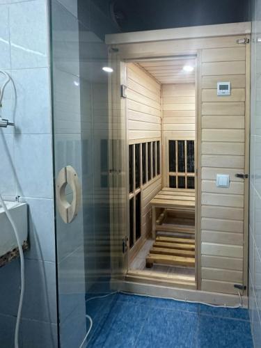 a sauna in a bathroom with a walk in shower at Samal Resort and SPA in Taraz