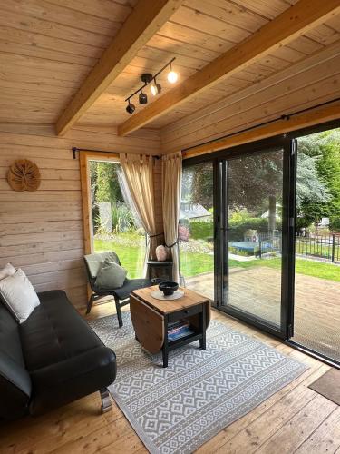 a living room with a couch and a table at Langdale Lodge in Inverness