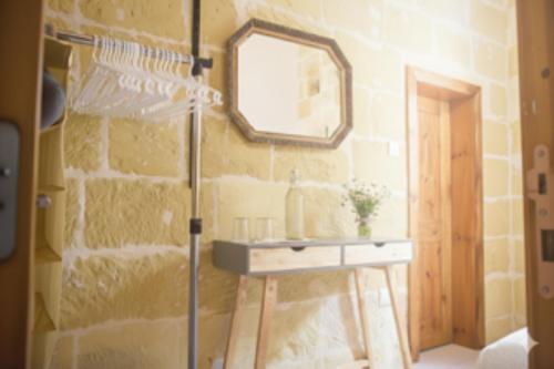 a bathroom with a sink and a mirror at St George of Lydda B&B in Victoria