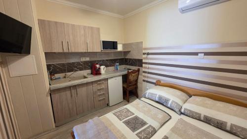 a small room with a bed and a sink at Green Szálláshely in Debrecen