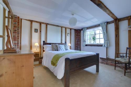 a bedroom with a large bed and a window at 1 Bed in Tenterden oc-tn621 in Tenterden