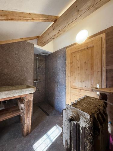 a room with a bed and a wooden wall at Baita dal Bigolaro in Vetriola