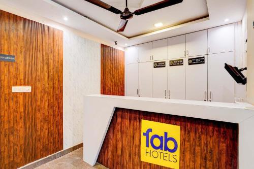 a lobby of a hotel with a sign on the wall at Via Emara Inn - Lalbagh Botanical Garden in Bangalore