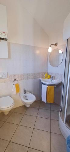 a white bathroom with a sink and a toilet at Bed & Breakfast Valeri in Artena