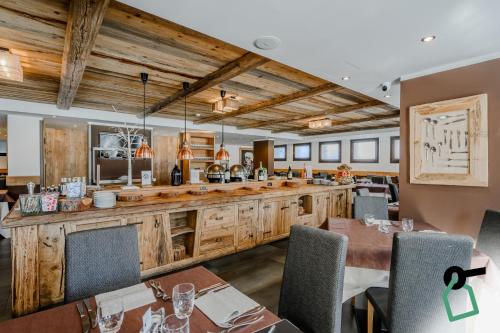 a dining room with tables and a bar at Hotiday Sestriere Ski Run in Sestriere