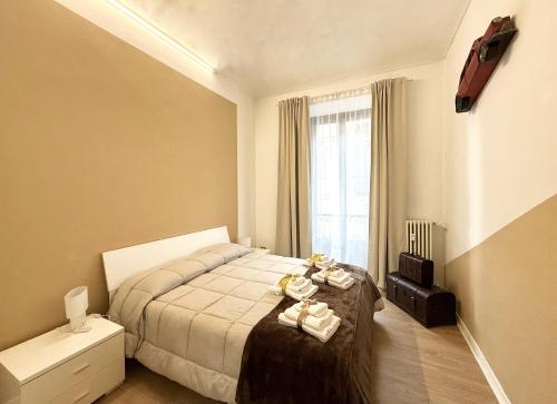 a bedroom with a bed and a window at Casa Telli - da Merilù in Turin