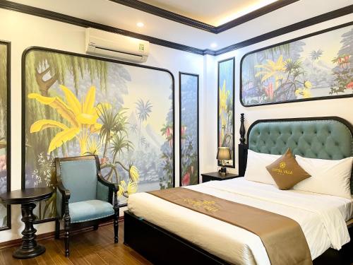 a bedroom with a king sized bed and a chair at Capital CauGiay Hotel in Hanoi