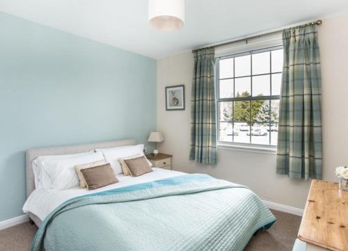 a bedroom with a large bed and a window at Mabels View in Melrose