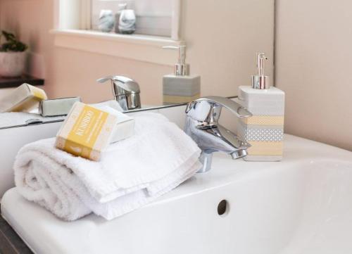 a bathroom sink with a towel and a faucet at Mabels View in Melrose
