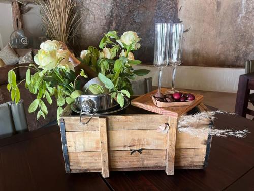 a table with two wooden boxes and flowers on it at Timbila Game Lodge - Welcome to Land of Leopards and Buffalo in Phalaborwa