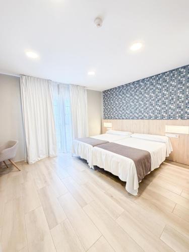 a large bedroom with a large bed in a room at Hotelet elRetiro in Cambrils