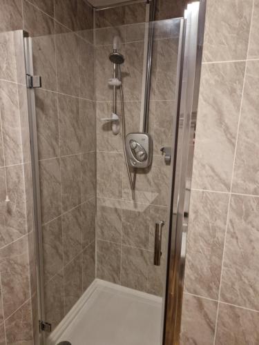 a shower with a glass door in a bathroom at Ynyscedwyn Arms in Ystradgynlais