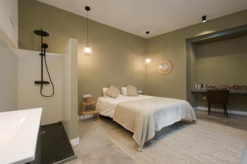 a bedroom with a bed and a bathroom with a sink at Casa Langlois in Telde